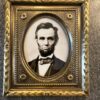 An embossed brass 3-3/4 x 4-1/2" frame of President Abraham Lincoln